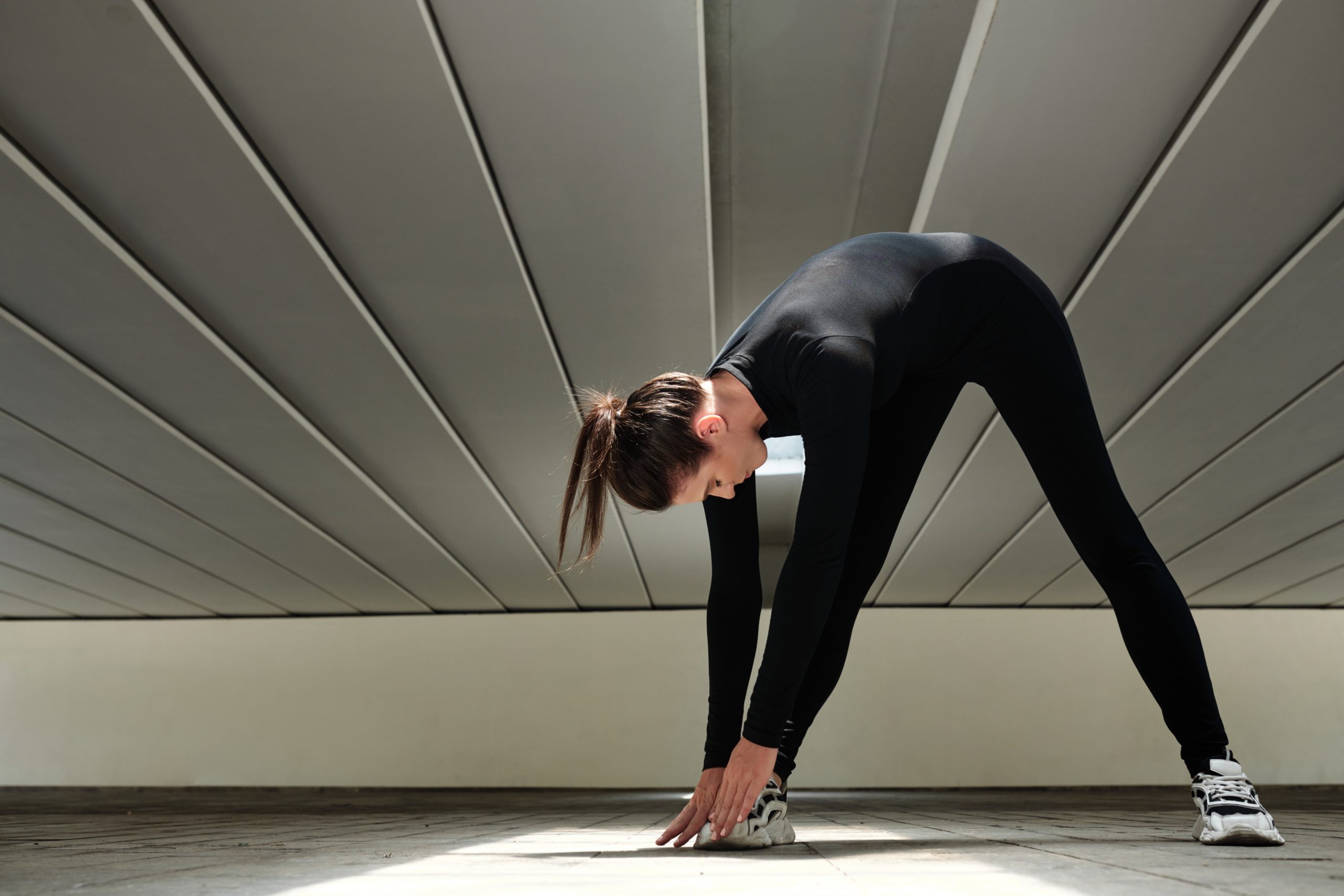 A woman doing stretches to help her body stay strong and resilient.