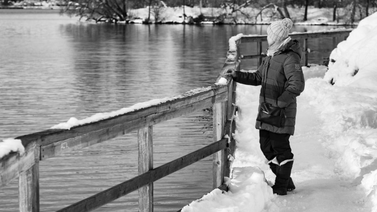 man standing on riverbank