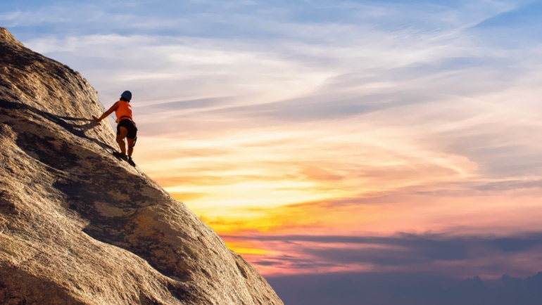 person staying motivated while climbing on mountain