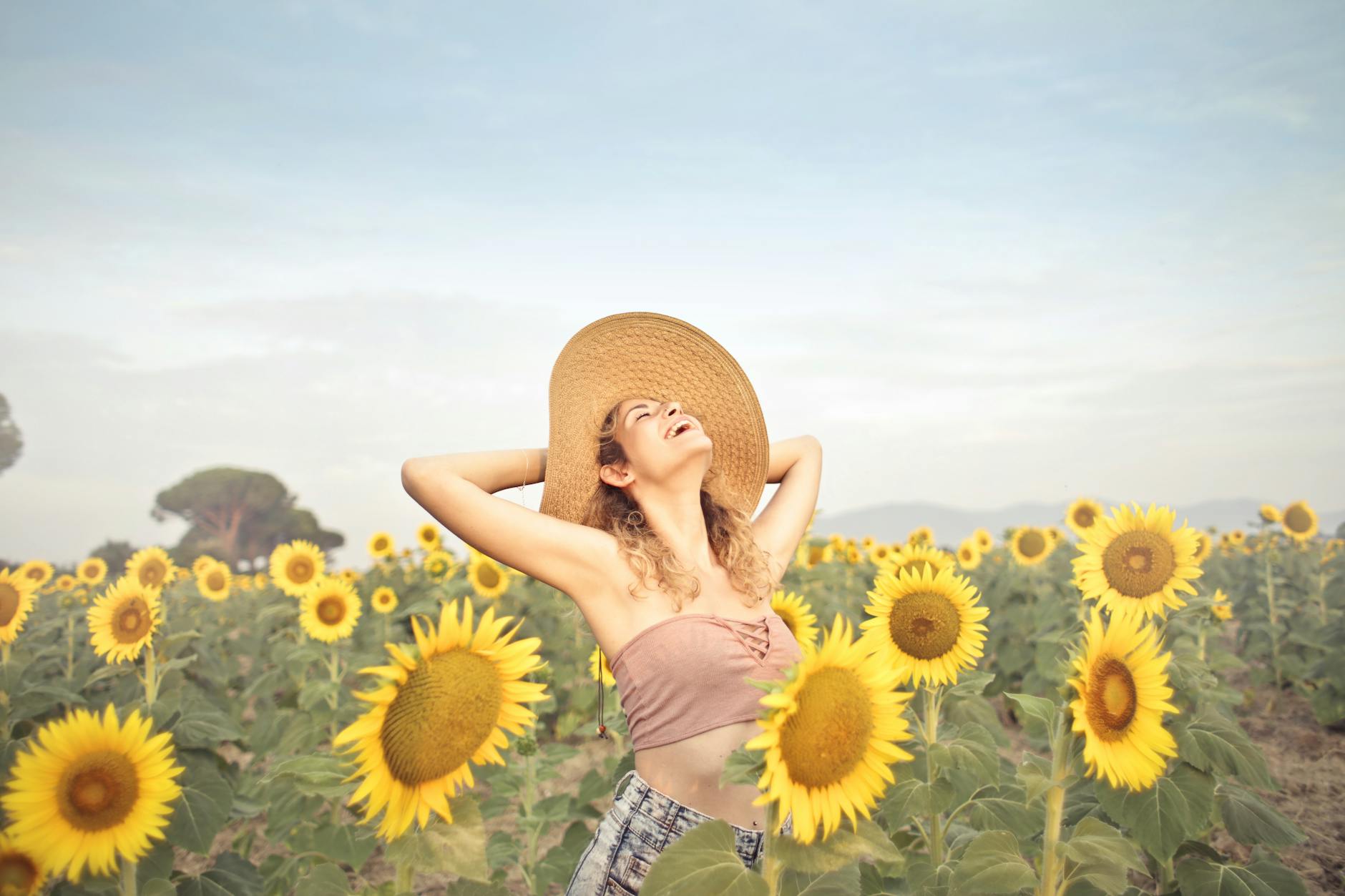 Managing Fibromyalgia flareups feels like stepping back into the sunshine again. Woman in a sunflower field