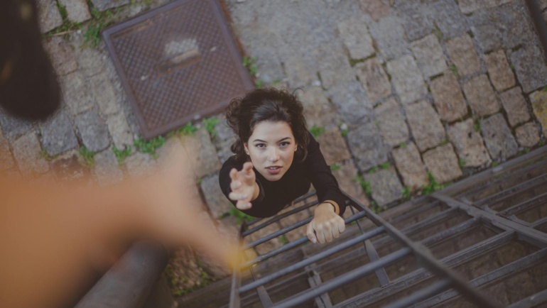 Woman on ladder trusting again.