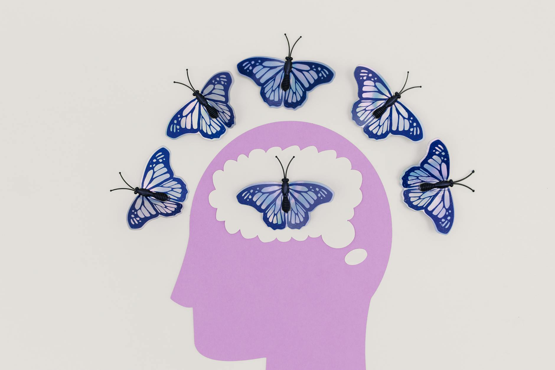Ways to improve your brain illustration of a head and butterflies around the scalp and inside the brain